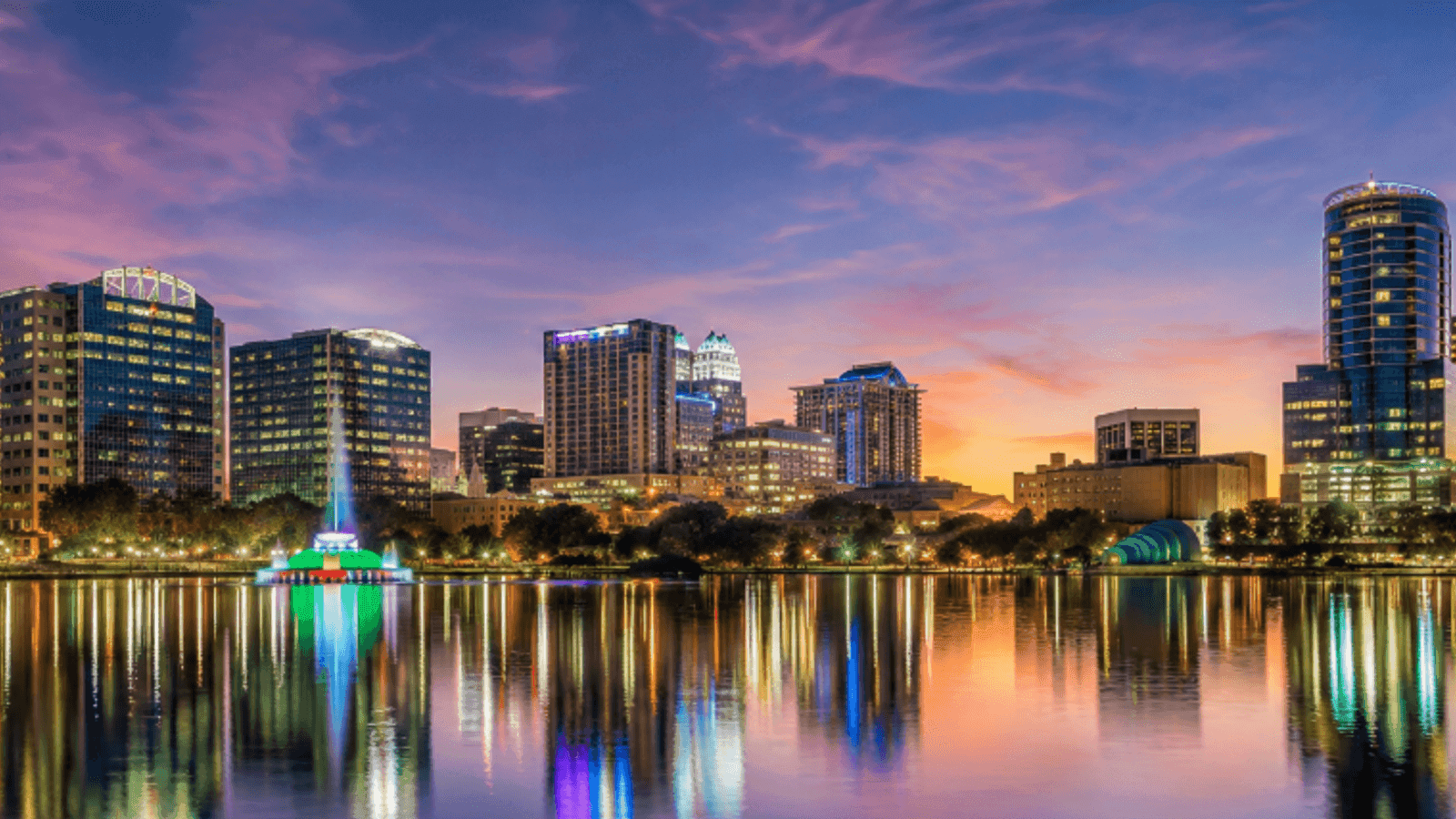 Downtown Orlando, Florida skyline reflected in a lake at dusk